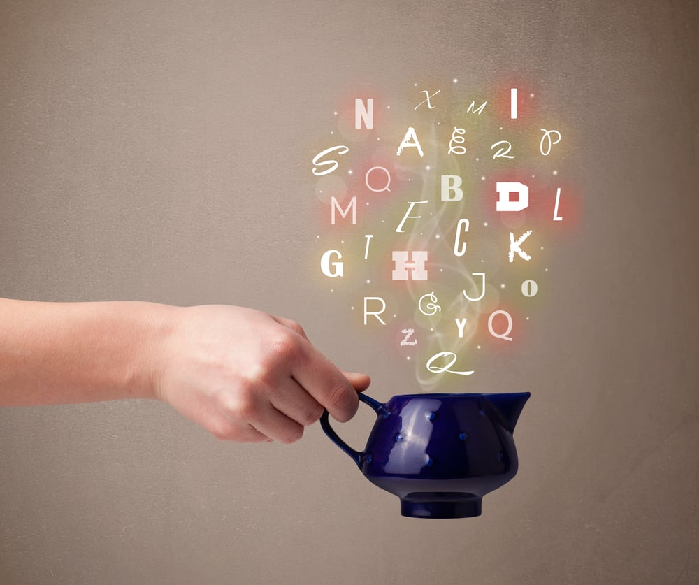 Tea pot with colorful letters, close up